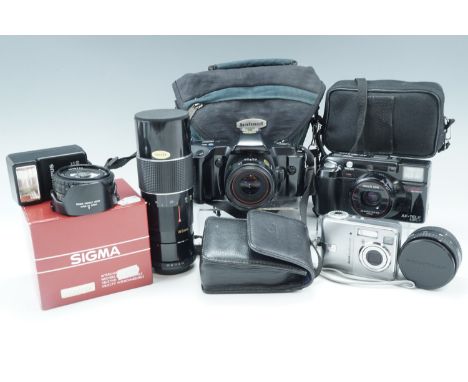 An Olympus OM 101 camera and flashgun, a Kodak Easyshare C340 camera, a Minolta AF-tele super camera, a Nikon lens series E 5