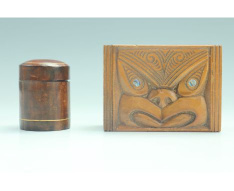 A New Zealand Maori influenced Paua shell inlaid carved wood trinket box, its lid decorated in depiction of a tiki, together 