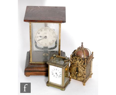 An early 20th century French Bulle oak cased mantle clock with open pendulum, height 26.5cm, a small French brass carriage cl