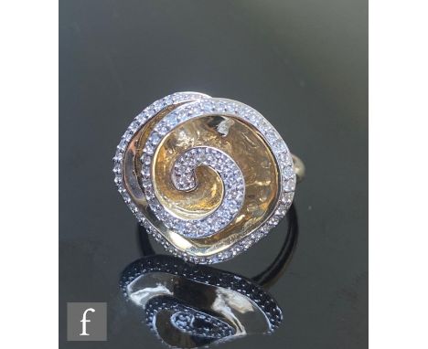 A 9ct hallmarked diamond set ring with a spiral of individually set stones to a shaped square head, diameter of head 20mm, we