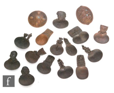 Fourteen assorted copper and base metal caddy spoons to include an Arts and Craft and souvenir examples, with two small coppe