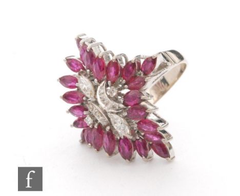 A 14ct white gold ruby and diamond cluster ring, twin central marquise and eight further diamonds within a twenty four marqui