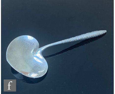 An American sterling silver caddy spoon with heart shaped bowl and berry and leaf decoration to handle, length 10cm, weight 1