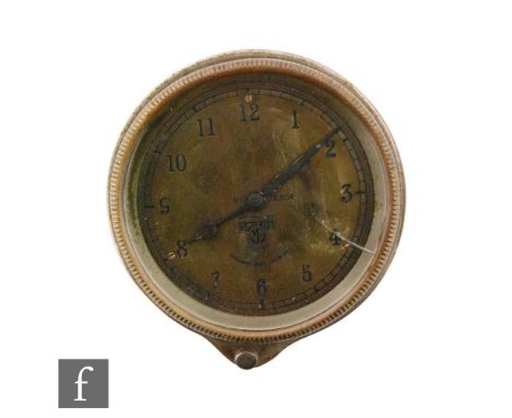 A 20th Century Smiths car dashboard clock, Arabic numerals to a brass dial, case diameter 9.5cm. 