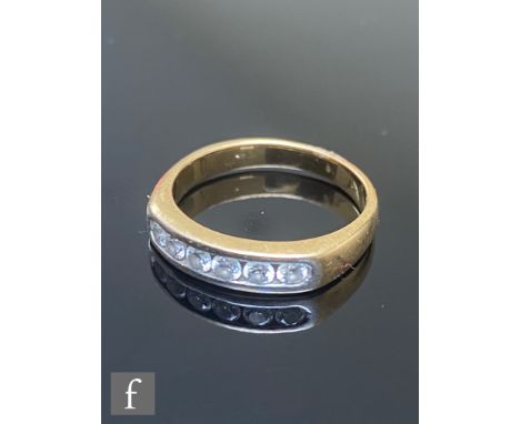 An 18ct diamond six stone half eternity ring, channel set brilliant cut stones to plain shank, diamond weight approximately 0