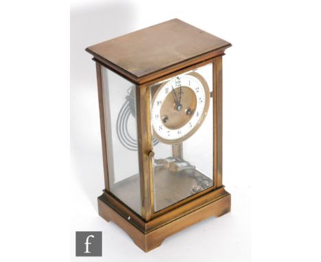 A 19th century French gilt brass mantle clock with suspended circular Arabic dial and mercury pendulum, striking on a gong on
