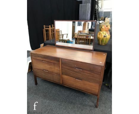 A 1960s teak dressing chest, with rectangular mirror bracket above an arrangement of six drawers with recessed grip handles, 