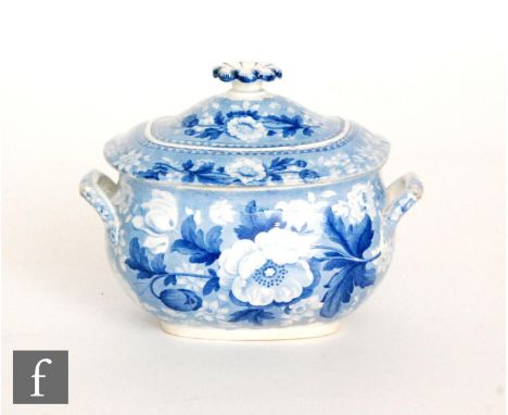 A small 19th Century Wedgwood tureen and cover decorated in a blue and white transfer print with flowers and foliage against 