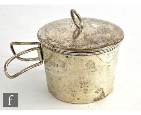 An early 20th Century hallmarked silver billy can of plain form with hinged twin handle and ring pull to cover, diameter 8.5c