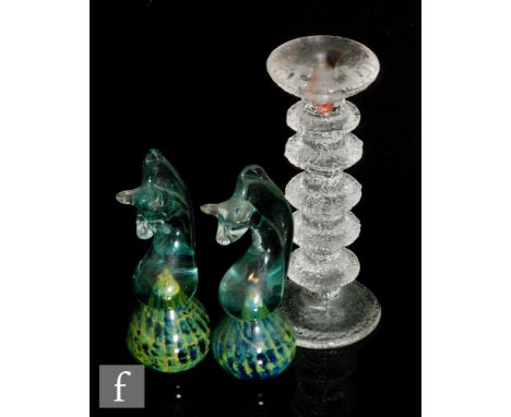 A pair of Mdina Seahorse paperweights with ovoid bases internally decorated with blue and green beneath a stylised horse figu