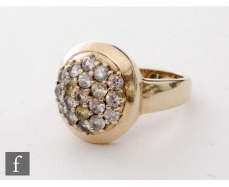 A 9ct hallmarked diamond ring with multi coloured brilliant claw set stones to an oval head, length of head 16mm, weight 4.8g