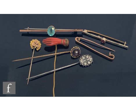 A 19th Century carved coral stick pin modelled as a hand with three further stick pins and three 9ct bar brooches, weight of 