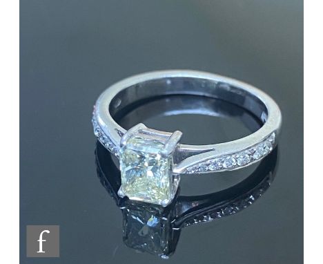 A platinum hallmarked diamond solitaire ring, emerald cut claw set stone weight 1.00ct, colour fancy yellow, clarity SI2, to 