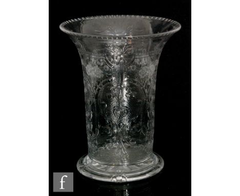 An early 20th Century Webb Corbett clear crystal vase of footed cylindrical form with a flared rim, heavily decorated with a 