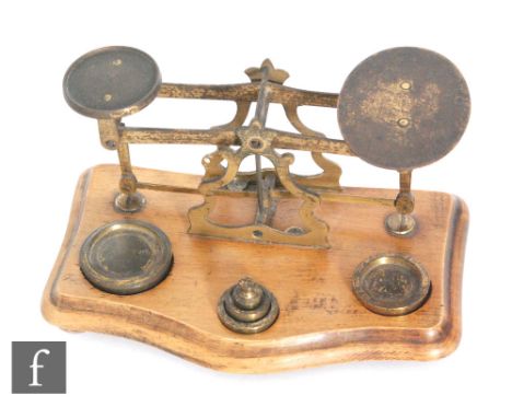 A set of Victorian brass letter scales with graduated set of brass weights, width 18cm. 