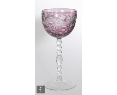 An early 20th Century Thomas Webb and Sons hock glass circa 1902, the ovoid bowl cased in amethyst over clear and intaglio cu