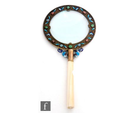 A 19th century Chinese magnifying glass, the lens bordered with a band of enamel flowers and cabochon coloured hard stones, t