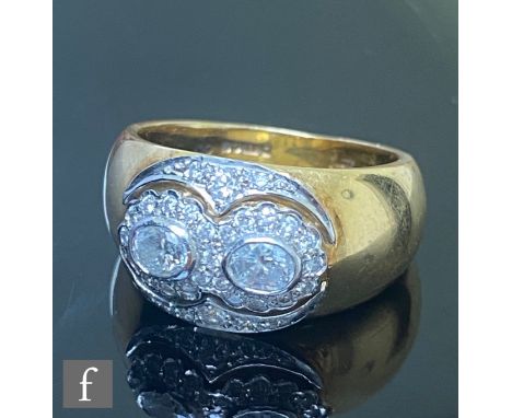 A 18ct hallmarked diamond cluster ring, two central oval collar set diamonds within a pave diamond set surround with pierced 