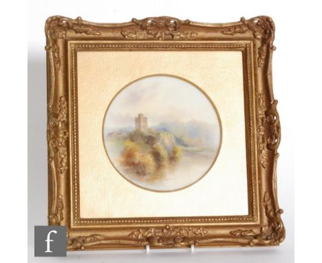 A framed Royal Worcester porcelain plaque decorated by J. Stinton with a hand painted castle beside a loch, signed, puce mark