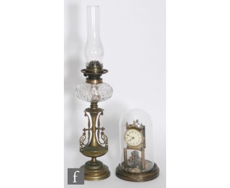 A 19th century Arts &amp; Crafts brass oil lamp with reservoir and burner (no shade), height 70cm, and a 365 day mantle clock