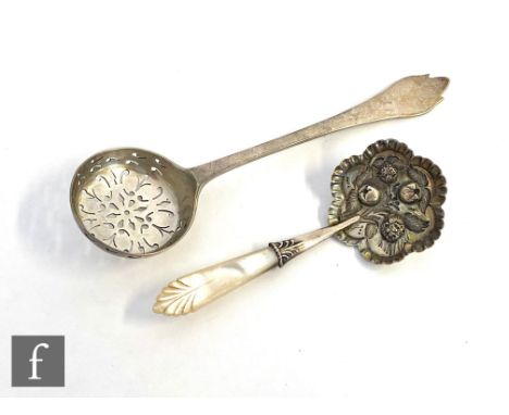 A Victorian hallmarked silver caddy spoon with embossed fruit to a rounded hexagonal bowl below mother of pearl handle, with 