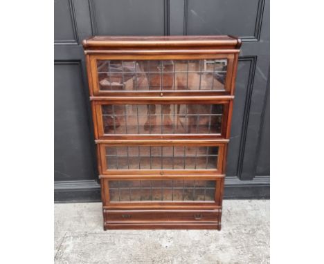 An early 20th century Globe Wernicke mahogany four tier sectional bookcase, with leaded glass panels, 86.5cm wide. 