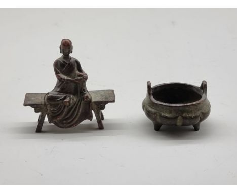 A miniature Chinese bronze twin handled tripod censer, seal mark to base, 5cm wide; together with a similar small bronze seat