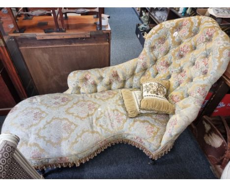 A Victorian button upholstered chaise longue, of shaped outline, approx 180cm wide. 