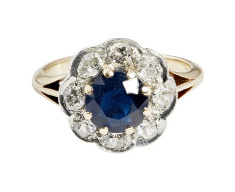A sapphire and diamond set cluster ringclaw set with a round cut sapphire, in a single border of old round cut diamonds, to a
