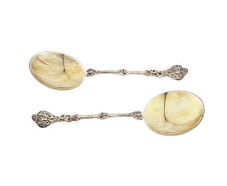 A pair of Victorian silver-gilt serving spoonsWilliam Hutton and Sons, London 1895, each with a cast shaped finial decorated 