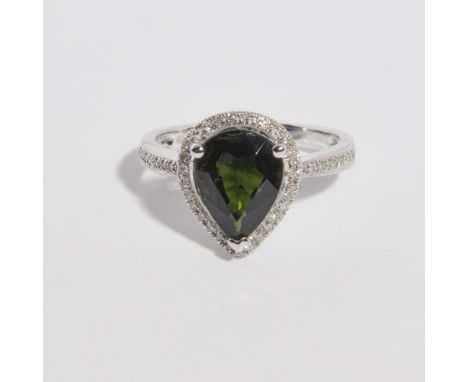 A tourmaline and diamond set ringclaw set with a pear shaped green tourmaline in a border of round brilliant cut diamonds, ea