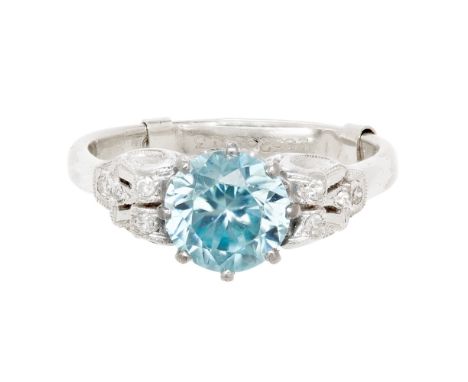 A blue zircon and diamond cluster ringclaw set with a round cut blue zircon, each shoulder set with three small eight cut dia