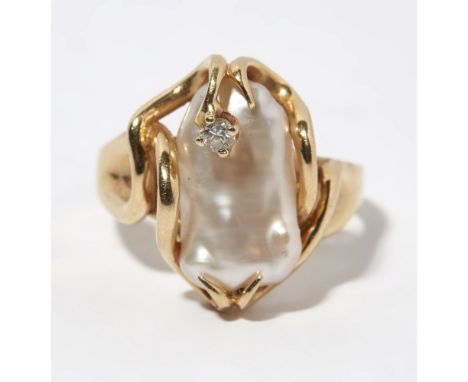 A pearl and diamond set ringclaw set in a stylised mount with a baroque pearl, with a single small round brilliant cut diamon