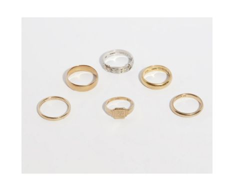 A collection of gold bandsto include two 18ct yellow gold wedding bands, an 18ct white gold band, two 9ct yellow gold wedding