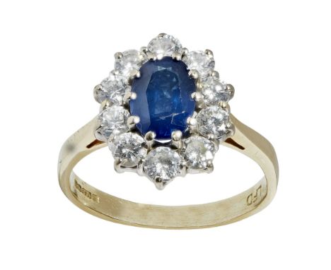 A sapphire and diamond set cluster ringclaw set with an oval cut sapphire in a border of ten round brilliant cut diamonds, to