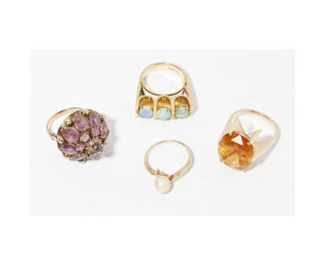 A collection of four gem set ringsto include a three stone opal set ring, stamped 14k; a citrine set ring, stamped 585; an am