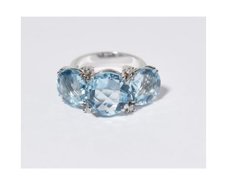 A large aquamarine and diamond set dress ringclaw set with three graduated round mixed cut aquamarines, with small round bril