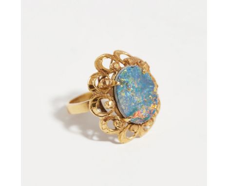 An opal set cocktail ringclaw set with an oval black opal doublet, in a stylised foliate border, to a plain shank, indistinct