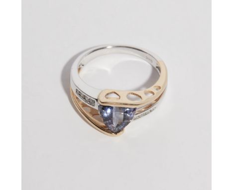 A Tanzanite and diamond set ringset with a trilliant cut tanzanite, the split shoulders each set with four round brilliant cu