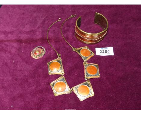 A handmade brass and copper matching necklace, bangle and brooch.
