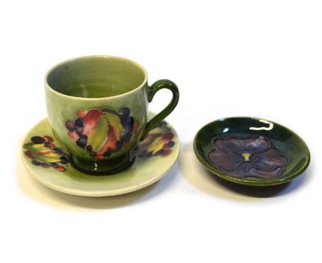 Moorcroft Leaf and Berry coffee cup and saucer on light green ground together with a Pansy pin dish on green ground. Saucer 1