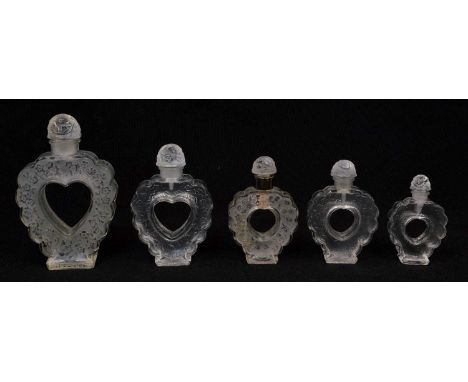 5 Lalique Nina Ricci 'Coeur Joie' heart shaped perfume bottles in various sizes with frosted and clear crystal floral heart s