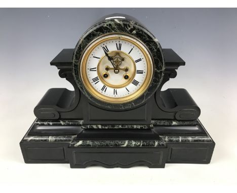 A large variegated marble and polished black slate drum head mantel clock, the French movement having Breguet open-escapement