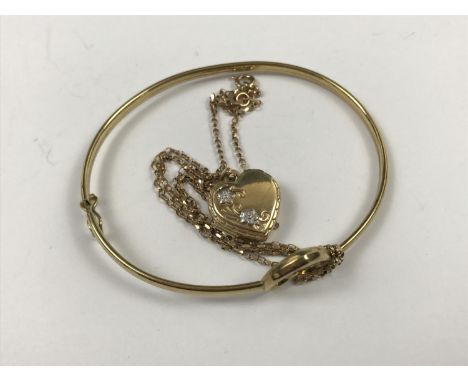 A 9ct gold locket on chain, together with a 9ct gold bangle having a diamond-set open heart design, 5.8g