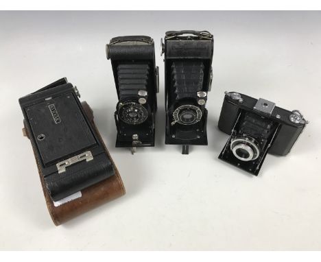 Four vintage folding roll-film cameras, including a Kodak Six-20 Junior, Voigtlander 'Bessa', Nettar 515/16 and a Kodak Eastm