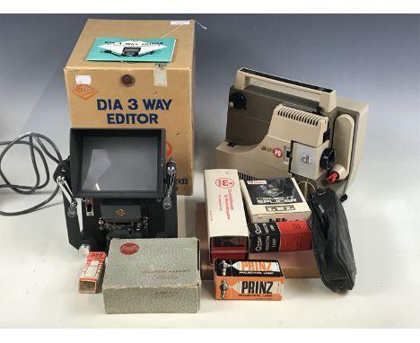 A boxed Eumig projector and an editing tool