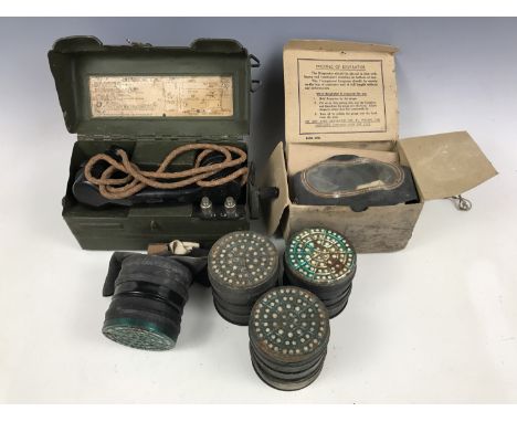 A British Army Type L field telephone and two Second World War civilian gas masks and filters