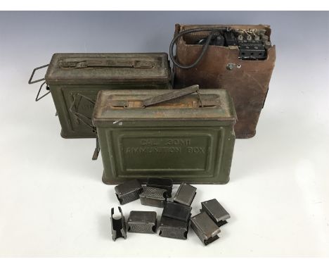 A Second World War US Army field telephone, two .30-calibre ammunition boxes and Garand rifle cartridge clips
