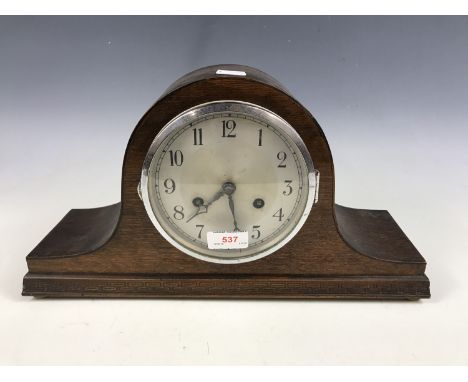 A 1920s oak "Napoleon's hat" mantel clock