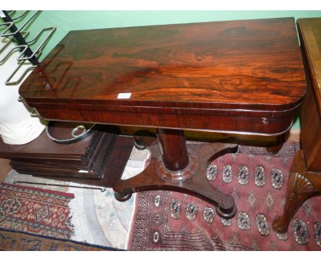 A Regency Rosewood flap-over card table having a tapering cylindrical, the platform base with compressed turned bun feet and 